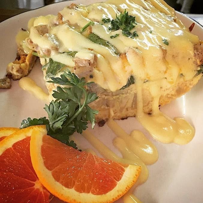 A hearty breakfast topped with hollandaise sauce